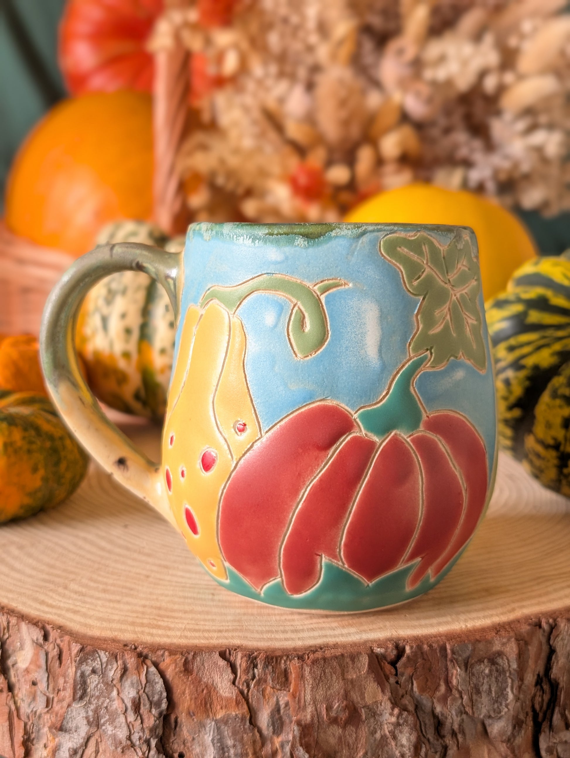 Whimsical fall mugs with hand-glazed pumpkin and gourd artwork, perfect for autumn drinks