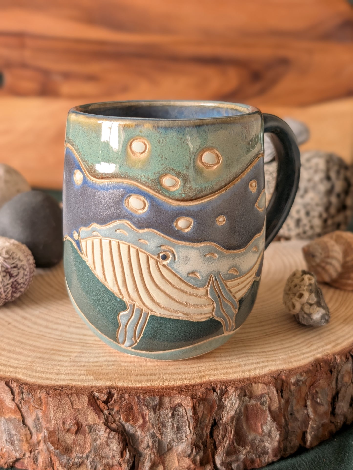Unique ocean-inspired pottery mug featuring carved whale design in blue ceramic