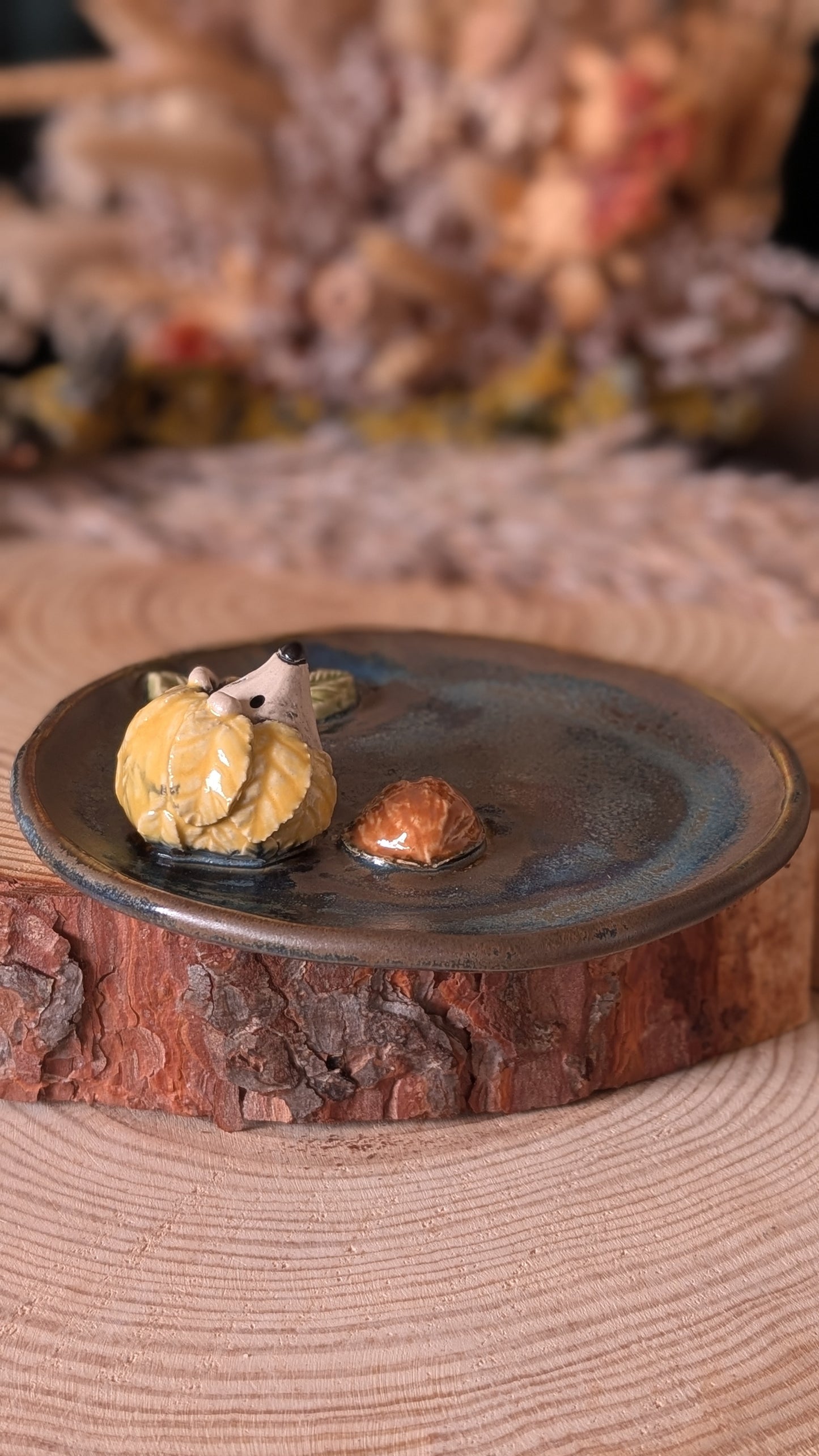 Handmade Hedgehog with Walnut on a ceramic dish.